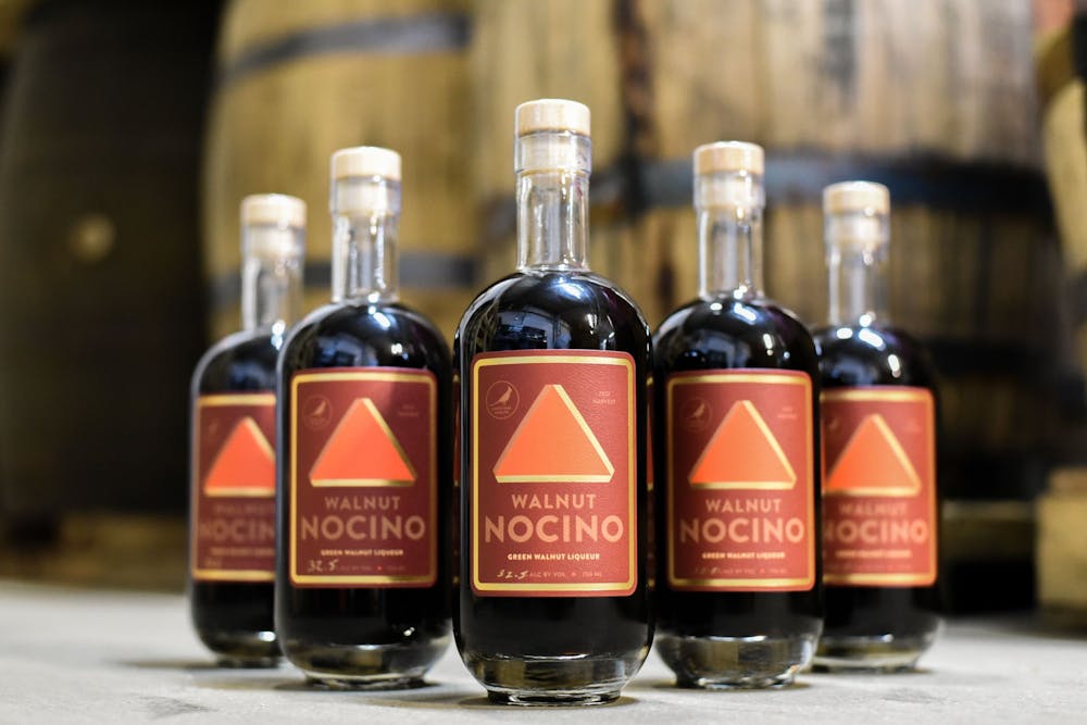 <p>Cardnial Spirits&#x27; Nocino bottles are seen displayed in front of barrels. Nocino will be rereleased for a limited time ﻿Nov. 4.</p>