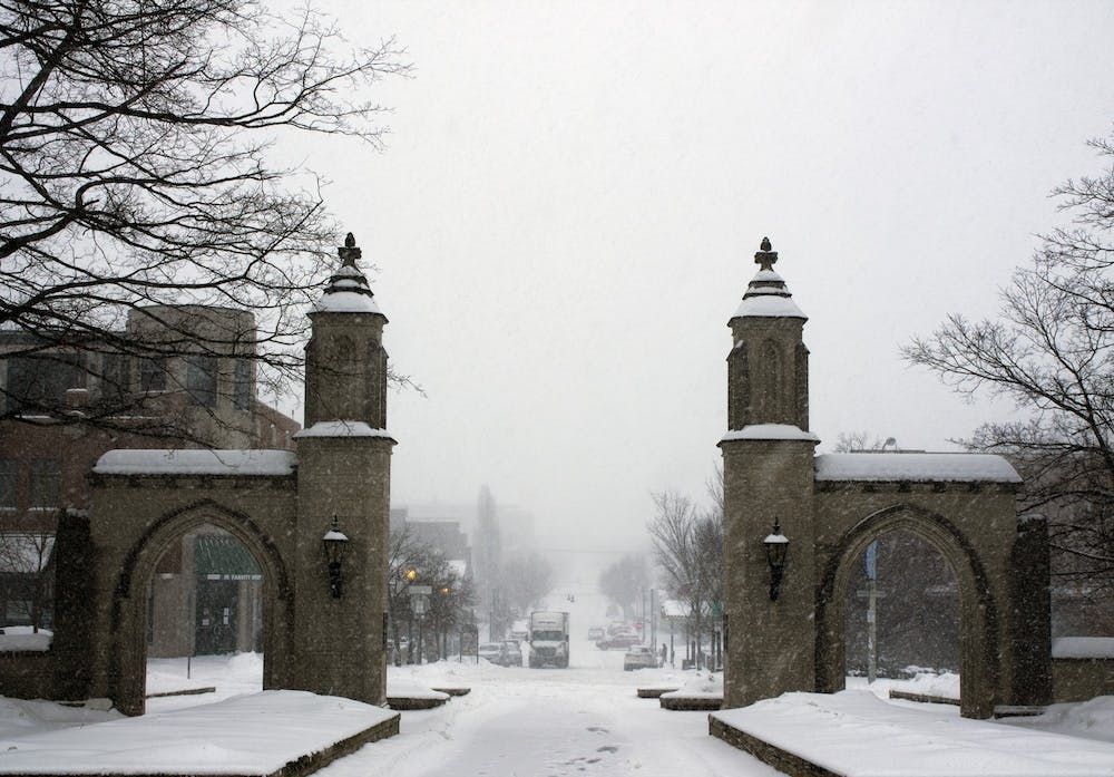 <p>﻿Snow flurries fall near the Sample Gates on Feb. 15, 2021. IU welcomes students back to campus on Monday, Jan. 9, 2023, for the start of the spring semester.</p>