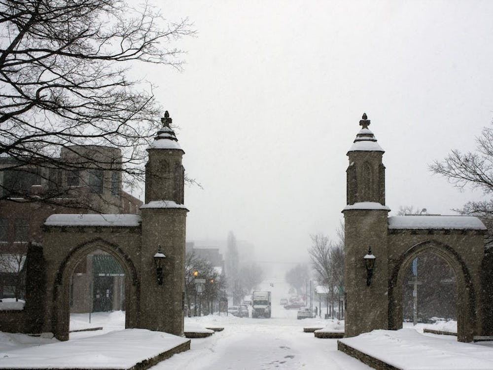 ﻿Snow flurries fall near the Sample Gates on Feb. 15, 2021. IU welcomes students back to campus on Monday, Jan. 9, 2023, for the start of the spring semester.