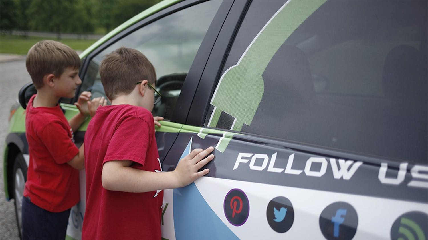 From left, second grade students Levi Schroeder and Mason Powwell look inside the EnergyMobile Wednesday at Marlin Elementary School.  The car visited three local schools throughout the day to promote sustainability to students. 