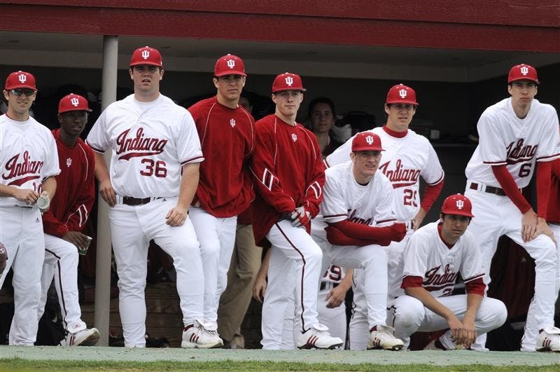 IU players watch the action from the dugout during a game against Minnesota on Friday at Sembower Field. IU lost 12-5.