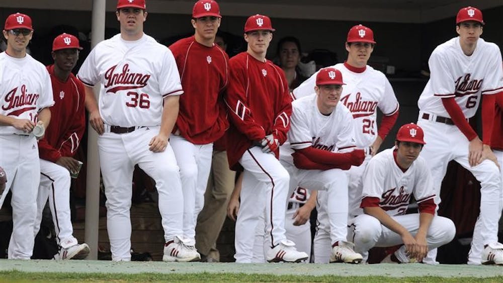 IU players watch the action from the dugout during a game against Minnesota on Friday at Sembower Field. IU lost 12-5.
