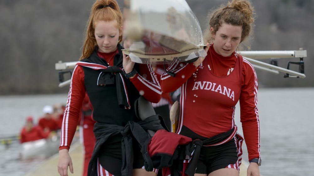 Then-sophomore Sophia Wickersham, now a junior, and then-junior Caroline Taylor, now a senior, move their boat after competition during the 2017 season. IU traveled north to Michigan this weekend, and lost to Michigan State.&nbsp;