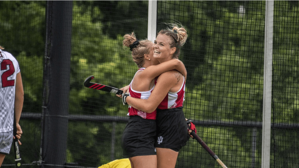 Claire Woods, left, and Ciara Girouard, right, celebrate scoring against Stanford on Sept. 7 after a goal by Woods at the IU Field Hockey Complex. The Hoosiers will play Maryland and Rutgers this weekend.