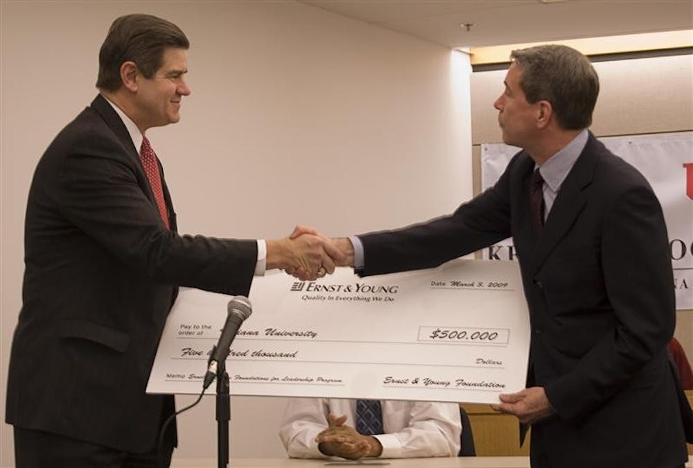 CEO and Chairman of Ernst & Young Jim Turley presents Dean of the Kelley School of Business Dan Smith with a $500,000 check donated for diversity development Tuesday afternoon at the Godfrey Graduate and Executive Education Center.