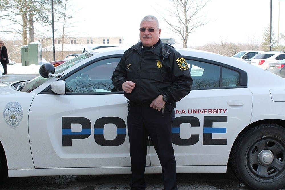 Captain of Operations Tom Lee stands in front of a police car on March 2, 2015. Lee has been on IU's police force for 19 years.