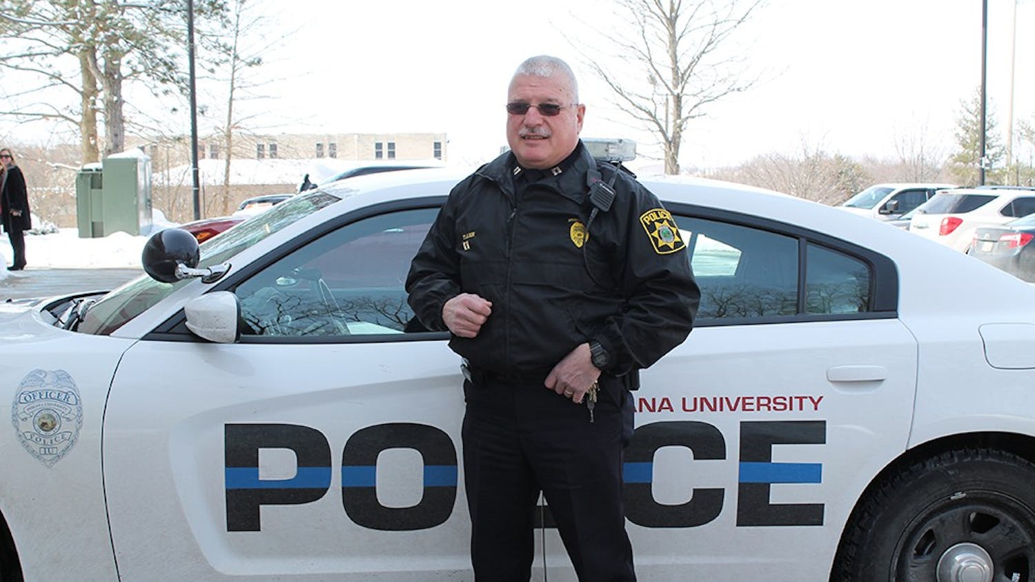 Captain of Operations Tom Lee stands in front of a police car on March 2, 2015. Lee has been on IU's police force for 19 years.