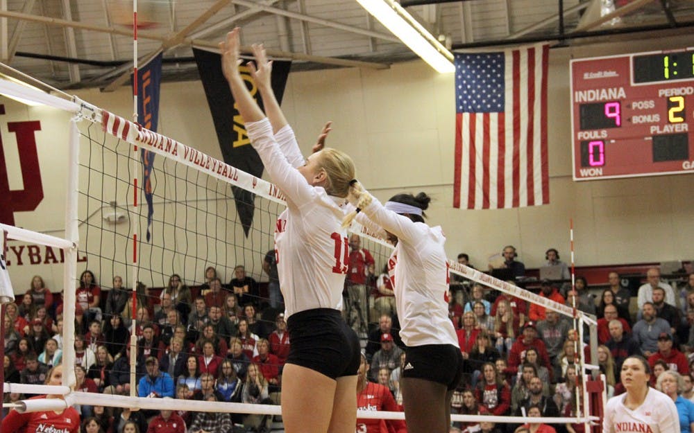 Mallory Waggoner (left) and Jazzmine McDonald block the ball as IU Volleyball competes against Nebraska on Saturday.