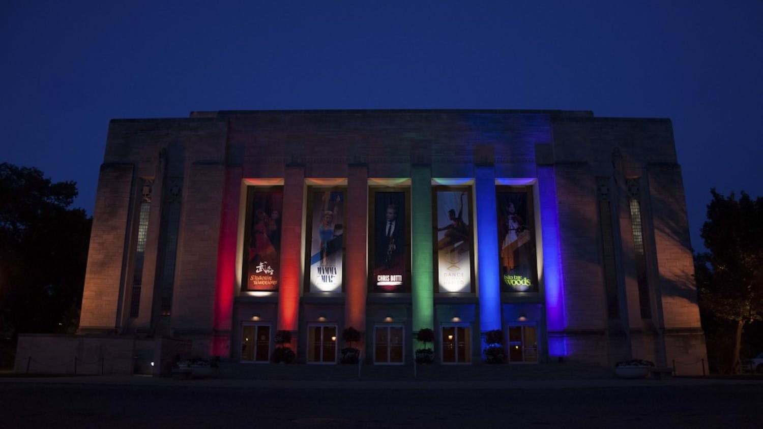The Indiana University Auditorium lights up in Pride colors as a memorial for the Orlando mass shooting victims on Monday evening.
