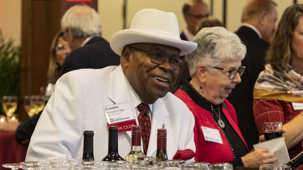 IU Alumni Association life member Franklin Breckenridge smiles while ordering a drink Oct. 10 in Alumni Hall. IU alumni could drink and converse before having dinner. 