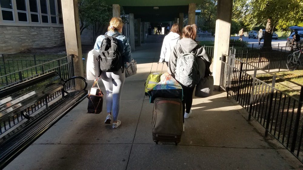 Freshmen Alessia Borzaro and Olivia Ranucci move their belongings out Oct. 17 from their room in McNutt Quad. The quad is one of many living spaces on the northwest side of campus with mold problems.
