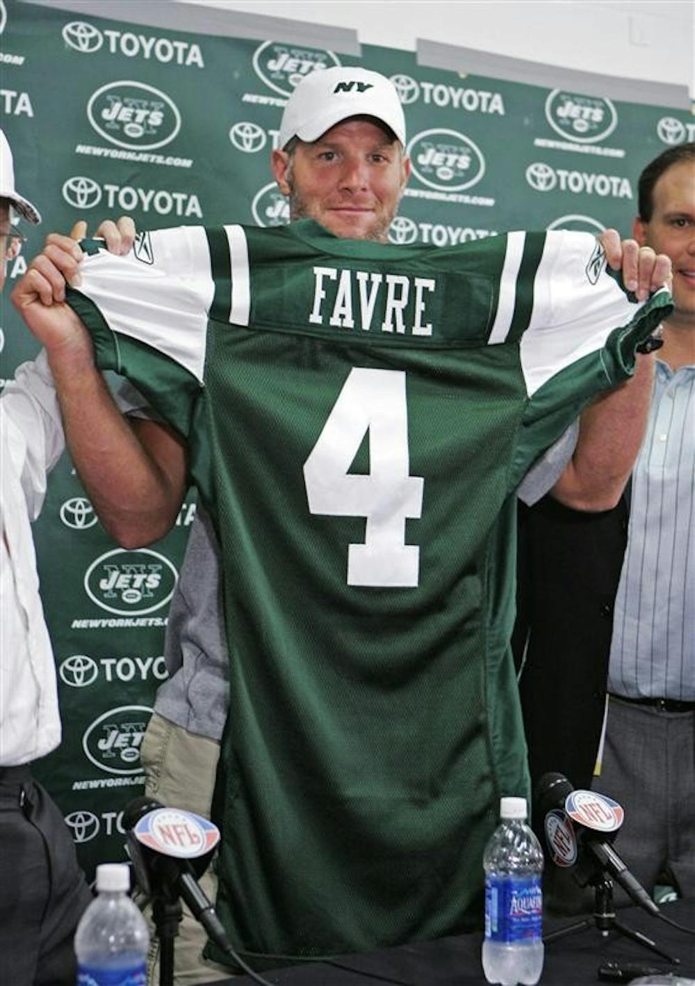 Brett Favre holds up his new New York Jets jersey at Cleveland Browns Stadium before an NFL exhibition football game between the Jets and the Cleveland Browns on Thursday in Cleveland. Favre was traded from the Green Bay Packers to the Jets earlier in the day.