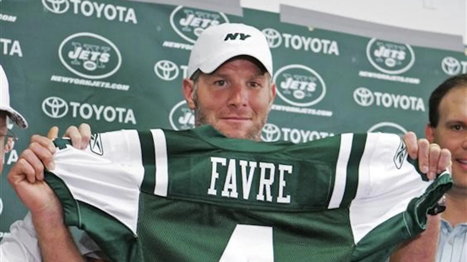Brett Favre holds up his new New York Jets jersey at Cleveland Browns Stadium before an NFL exhibition football game between the Jets and the Cleveland Browns on Thursday in Cleveland. Favre was traded from the Green Bay Packers to the Jets earlier in the day.