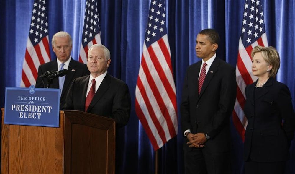 Defense Secretary Robert Gates, second left, speaks as Vice President-elect Joe Biden, left, President-elect Barack Obama; and Secretary of State-designate Hillary Rodham Clinton, far right, listen during a news conference Monday in Chicago. Gates, an IU alumnus and President Bush's Pentagon chief, will continue in that role in the new Obama administration.