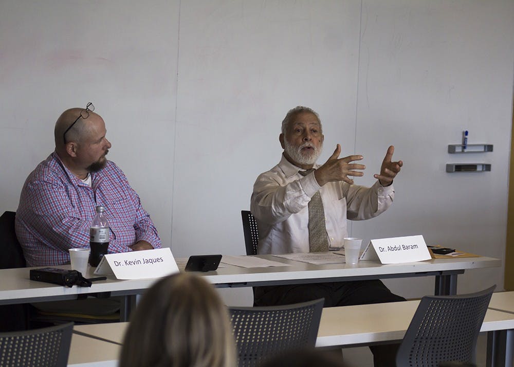 Dr. Abdul Baram (right) answers a question from Dr. Kevin Jacques (left). The Pi Lambda Phi fraternity set up the Islamophobia discussion panel Tuesday night in the School of Global and International Studies building.&nbsp;