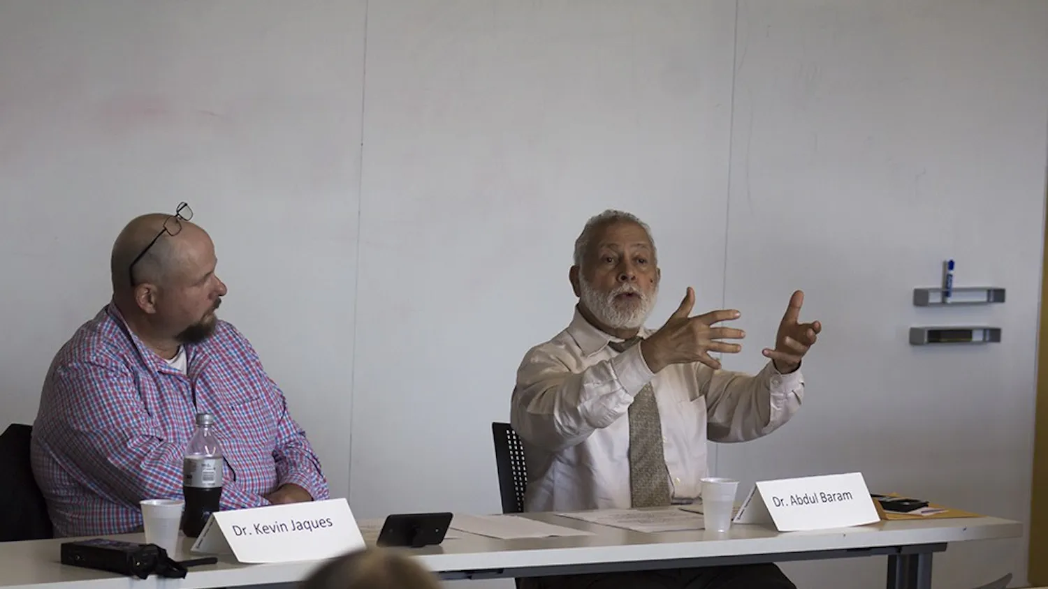 Dr. Abdul Baram (right) answers a question from Dr. Kevin Jacques (left). The Pi Lambda Phi fraternity set up the Islamophobia discussion panel Tuesday night in the School of Global and International Studies building. 