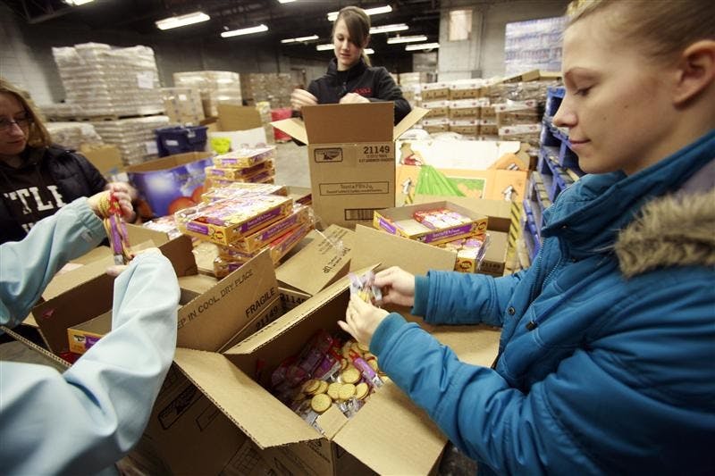 Butler students open the last cases of 10 skids containing peanut butter crackers to be destroyed At Gleaners Food Bank Saturday in Muncie, Ind.. The loose crackers will then be wetted with water to prevent human consumption after they are discarded by the food bank. Gleaners Food Bank destroys products containing peanut butter as part of the nation wide recall of foods containing Salmonella tainted products from Peanut Corp. of America.
