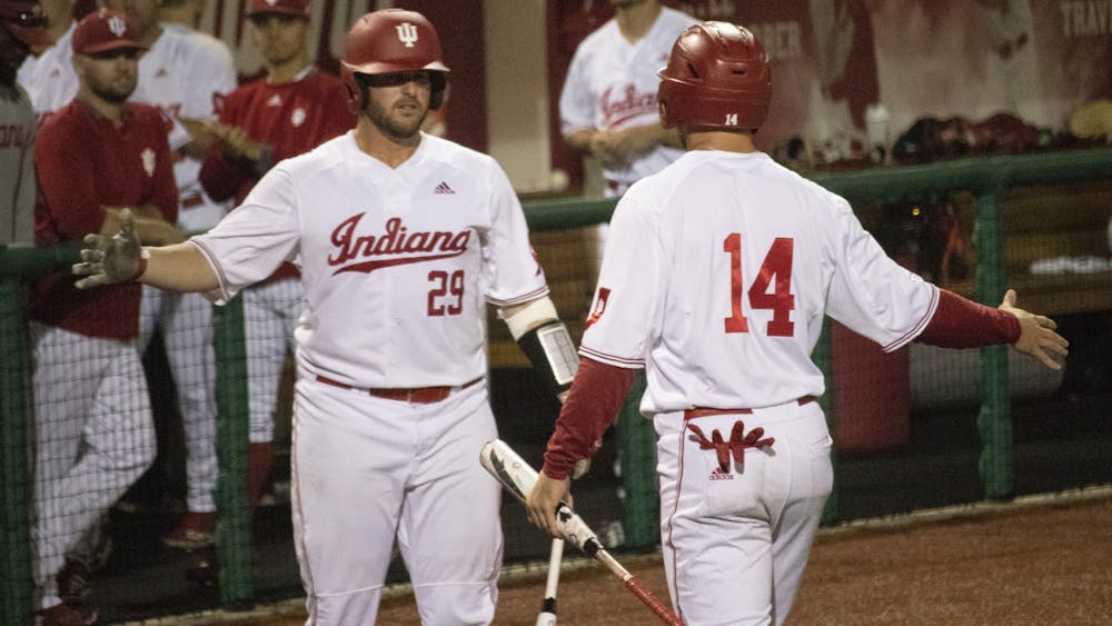 Then-senior catcher Ryan Fineman prepares to high-five senior utility Matt Lloyd on May 16, 2019, at Bart Kaufman Field. IU won two of its three games during the Keith Leclair Classic this weekend in Greenville, North Carolina.