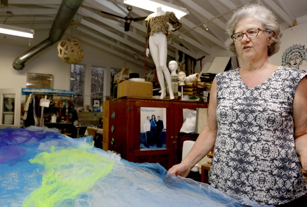 Gail Hale shows a recycled fabric, picked up at a sorority house. Hale has been using recycled materials to create art objects ever since she was young. This fabric was used in a trashion fashion event in 2016.&nbsp;