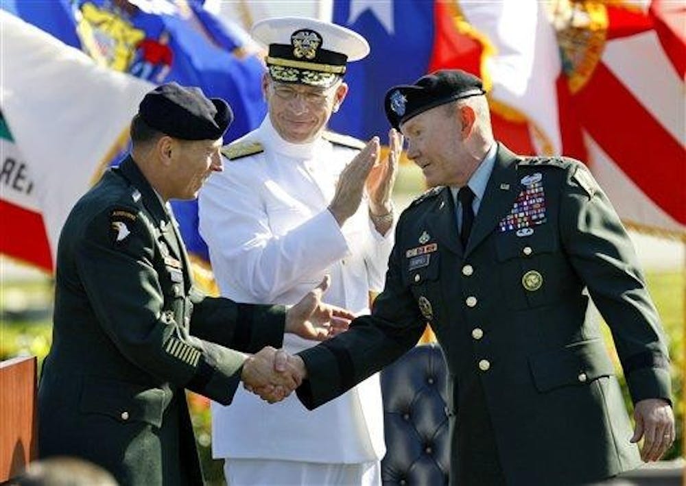 New head of the U.S. Central Command, U.S. Army Gen. David Petraeus, left, shakes hands with outgoing head U.S. Army Lt. Gen. Martin Dempsey, as U.S. Navy Admiral Mike Mullen, Chairman of the Joint Chiefs of Staff, looks on during Change of Command Ceremonies Friday morning Oct. 31 at MacDill Air force Base in Tampa, Fla.