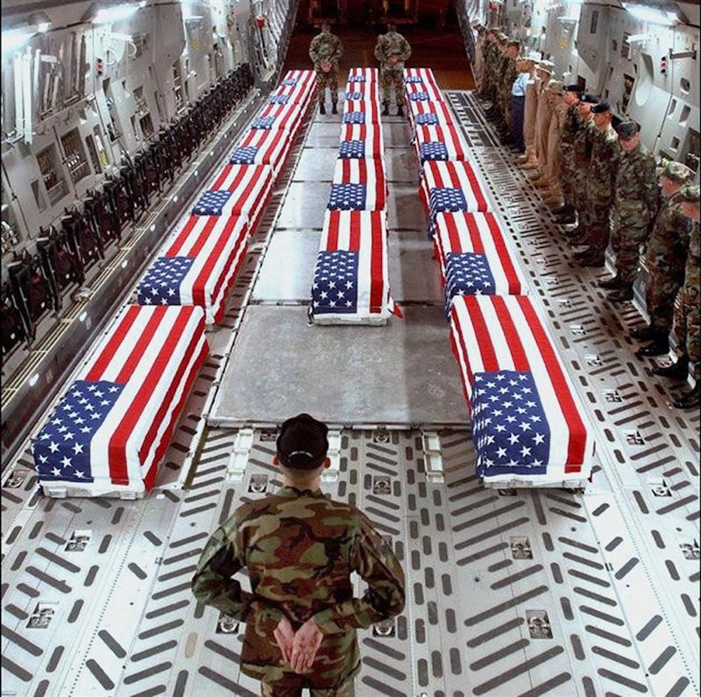 In this file photo, date unknown, made by the U.S. Department of Defense and obtained by thememoryhole.org, flag-draped coffins of U.S .war casualties are seen aboard a cargo plane in Dover, Del. President Barack Obama said Feb. 9 that his administration is reviewing a policy that bans the media from photographing flag-draped coffins of fallen U.S. soldiers. The president says his advisers are discussing with the Defense Department the prohibition on pictures of coffins returning from Iraq and Afghanistan.