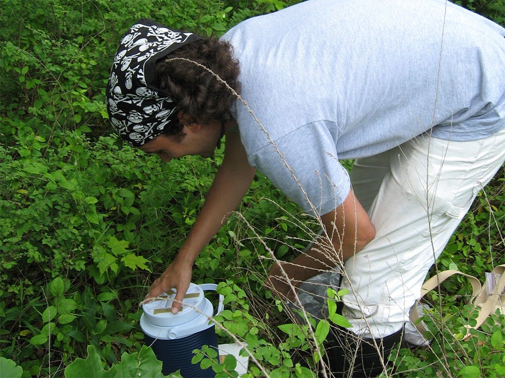 Field assistant Arian Avalos reloads a tick trap with dry ice.