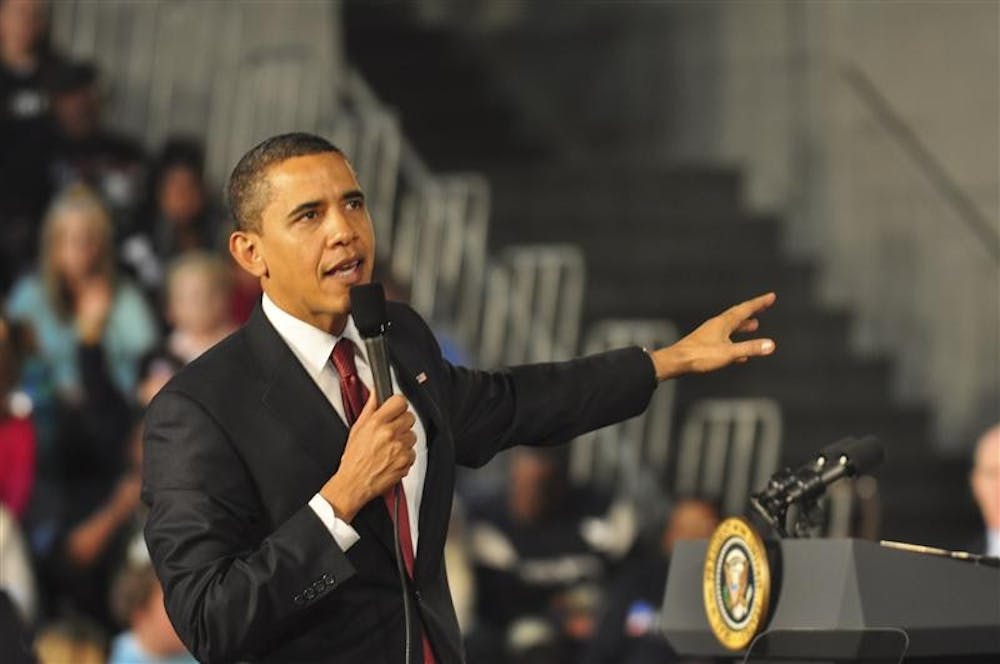 President Barack Obama gestures as he answers an audience member's question during his visit to Elkhart, IN February 9, 2009