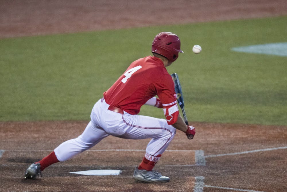 <p>Freshman Hunter Jessee bunts the ball March 7 at Bart Kaufman Field. The University of San Diego defeated IU 5-13 March 8.﻿</p>