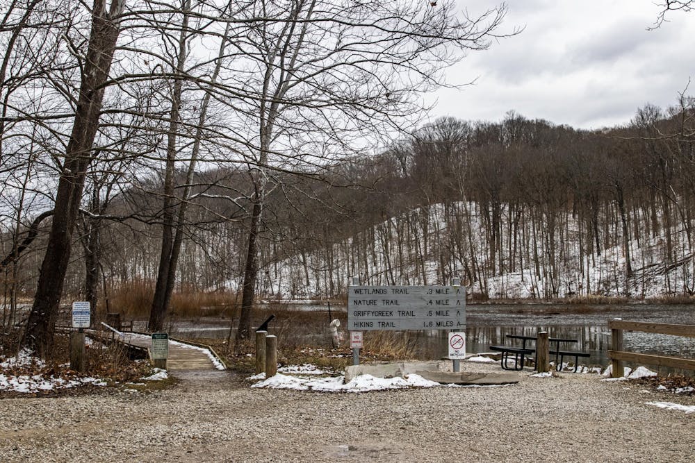 <p>A trail sign is seen in front of the waterfront Feb. 2, 2021, at Griffy Lake Nature Preserve. The Bloomington Parks and Recreation Department will conduct a 5.5 acre controlled burn Nov. 9.</p>