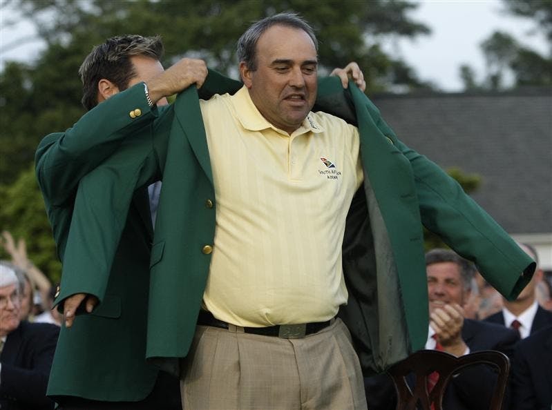 Former Masters' champion Trevor Immelman of South Africa helps 2009 Masters golf champion Angel Cabrera of Argentina with his Masters' green jacket at the Augusta National Golf Club in Augusta, Ga., Sunday, April 12, 2009.