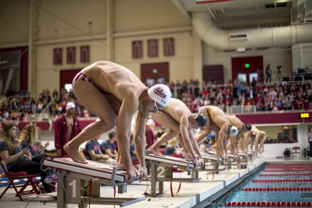 <p>Then-freshman Bruno Blasovic prepares to dive into the pool for the men's 100 freestyle finals. The men's swimming and diving team beat Purdue, 206-92, on Jan. 20.&nbsp;</p>