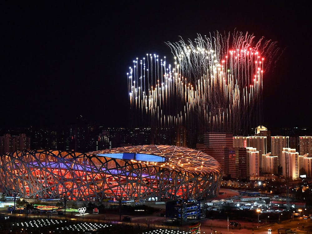 Fireworks in the shape of the Olympic rings go off Feb. 4, 2022, over the National Stadium during the opening ceremony of the Beijing 2022 Winter Olympic Games. Ellia Green, now the first Olympian to come out as a transgender man, appeared in the opening video shown at the Bingham Cup Summit addressing what it&#x27;s like to be a transgender athlete.