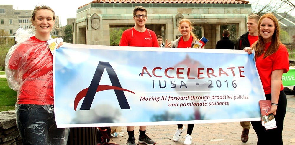 Amy Scobey, left, member of the Accelerate, and Stephanie Chinn, chief of marketing of the Accelerate, hold up a banner for the 2016 IUSA Election on Wednesday. The election will run from April 6 at 10 AM through April 7 at 10 PM.