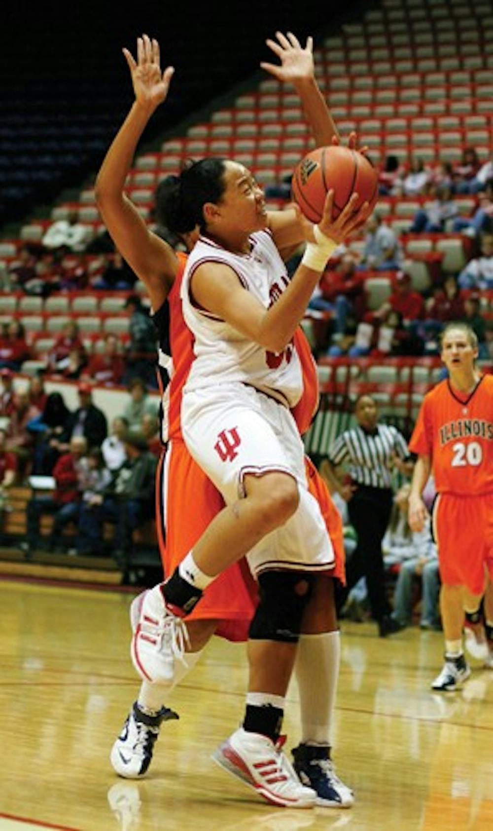 Brandon Foltz / IDS
IU junior guard/forward Kim Roberson passes an Illinois defender on her way to the goal Jan. 6 at Assembly Hall. The Hoosiers won 70-62.