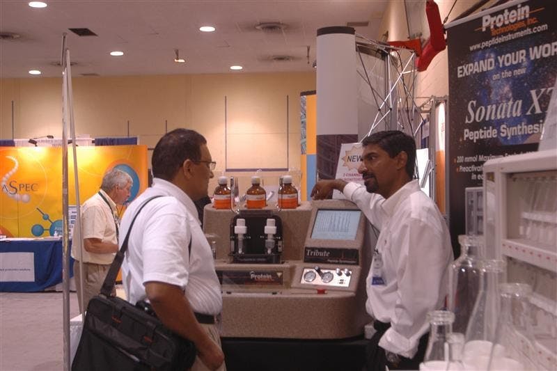 Mahendra Menakuru, right, chief operating officer of Protein Technologies, Inc., based in Tucson, Ariz., speaks with an attendee of the 21st American Peptide Society Symposium during a poster viewing session Tuesday at the School of Health, Physical Education and Recreation. The annual conference brings together researchers from around the world to share recent findings on the structure, function and synthesis of proteins.