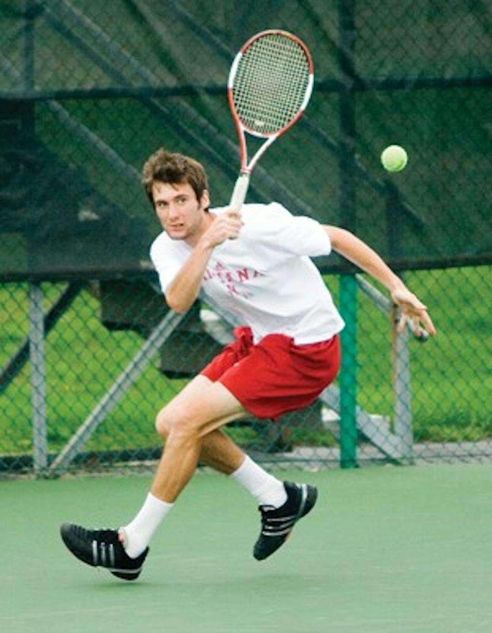 Junior Dara McLoughlin returns a shot against Michigan State at the IU Varsity tennis courts Saturday afternoon.  McLoughlin won his singles match 6-3, 6-1.