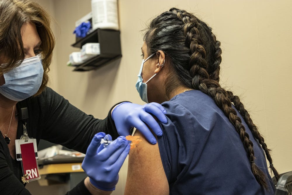 <p>Medical Assistance frontline worker Zaira Hernandez’s receives the first round of the COVID-19 vaccine Dec. 18, 2020, at the Employee Health Services building. Indiana residents aged 65 and older can now register to get the vaccine. </p>