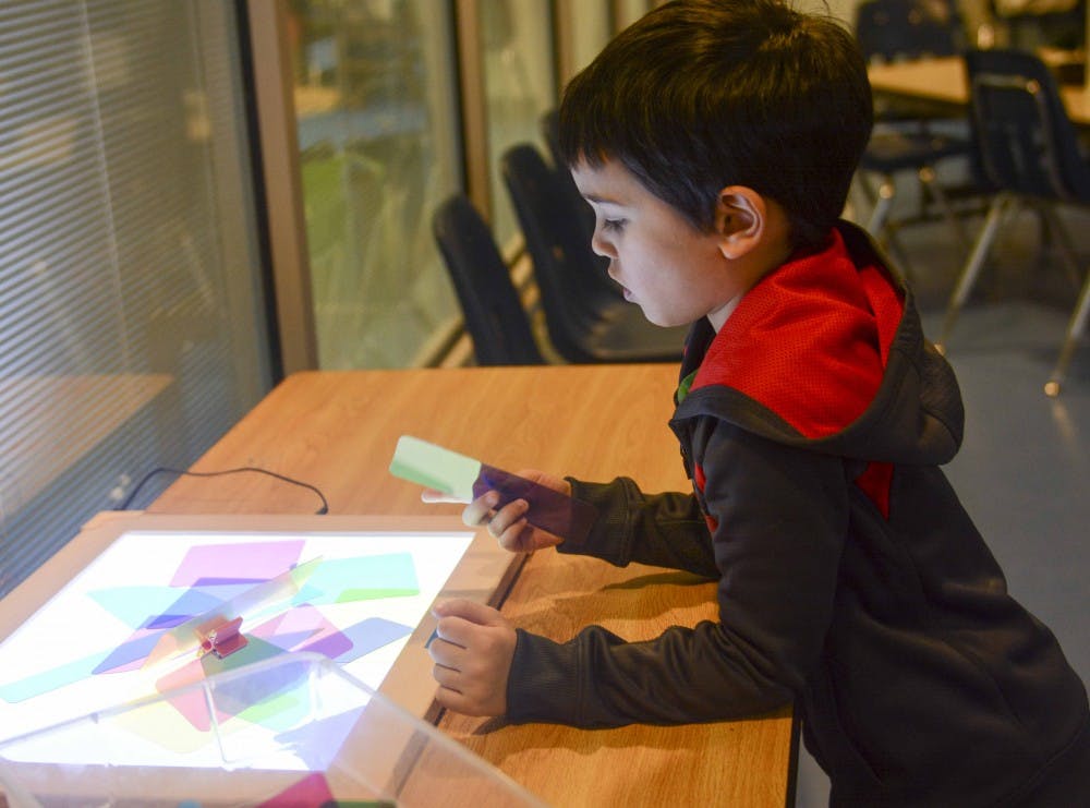 Layton Dhanawade experiences hands-on science lesson Tuesday morning at the Monroe County Public Library. 
