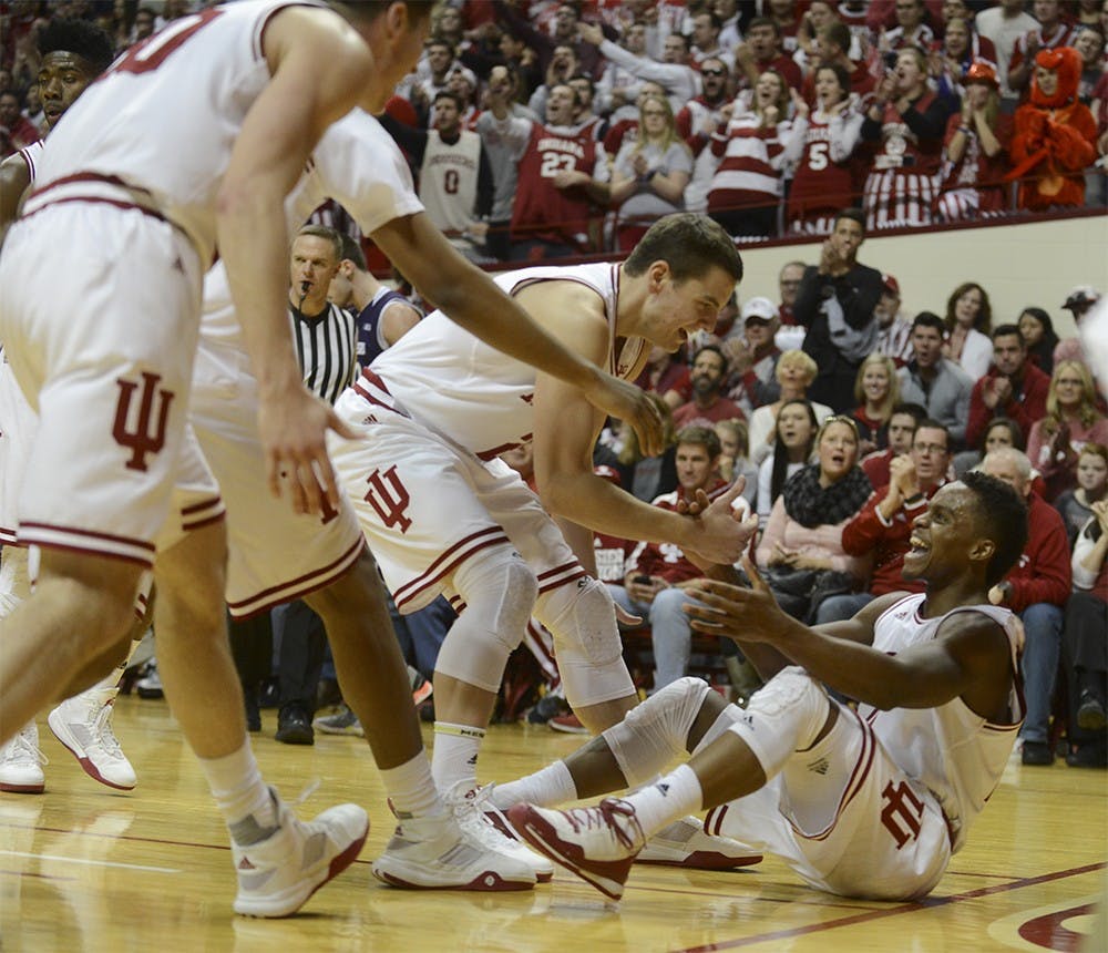 Teammates cogratulate senior Kevin "Yogi" Ferrell for drawing a foul against Northwestern on Saturday at Assembly Hall. IU won 89-57.