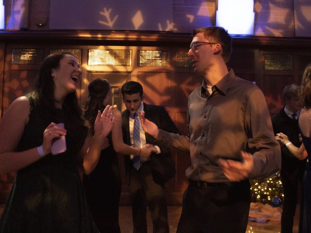 IU students Natalie Heald and Cooper Weingartner dance at the Yule Ball on Dec. 7 in the Indiana Memorial Union.&nbsp;