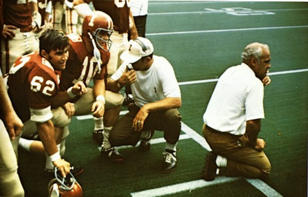 Former IU head football coach John Pont kneels on the sidelines during a game in 1970. Pont died Tuesday at his home in in Oxford, Ohio.