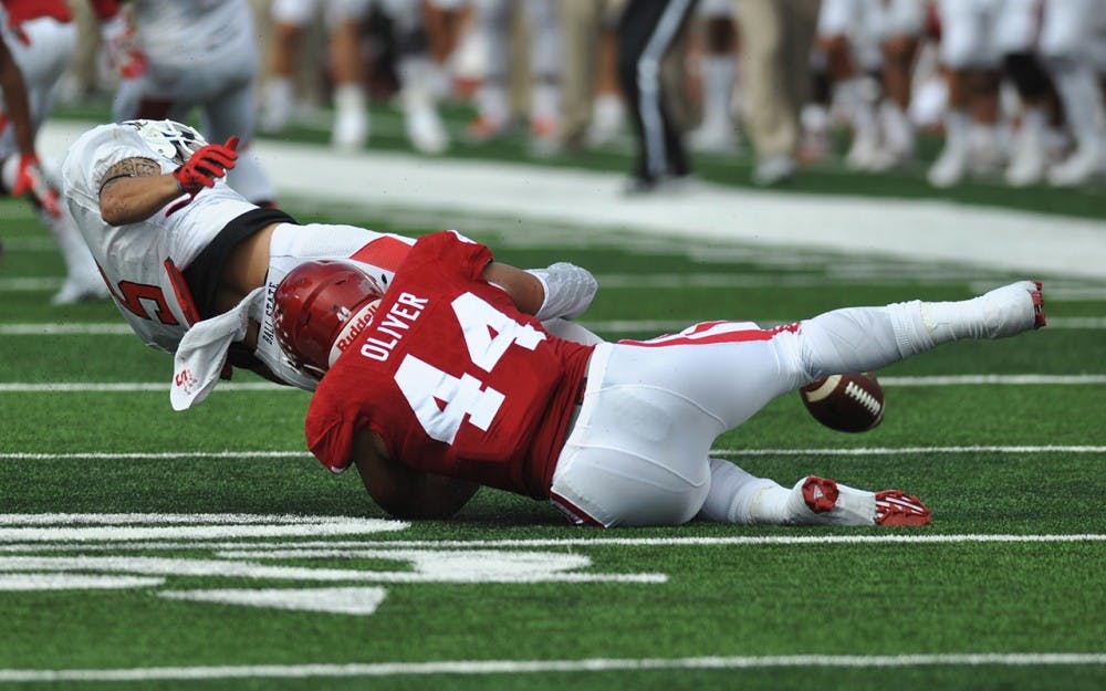 Junior linebacker Marcus Oliver forces a fumble early in IU's game against Ball State on Saturday at memorial stadium. IU won 30-20.