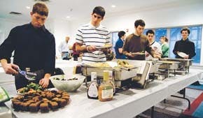 Students at the Hillel Center dish up food during a dinner for the center's Business Leadership Initiative group.  According to Hillel's website, the center is meant to be "a Jewish home away from home" for IU students.