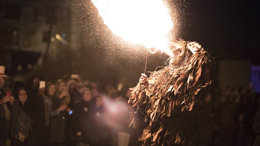 A person dressed as a Krampus spits fire at the Krampus Rampage and Bazaar in 2017. The rampage started with angels giving candy to children with "nice" stickers on and ended with the Krampus swatting children wearing "naughty" stickers with a bundle of sticks.&nbsp;