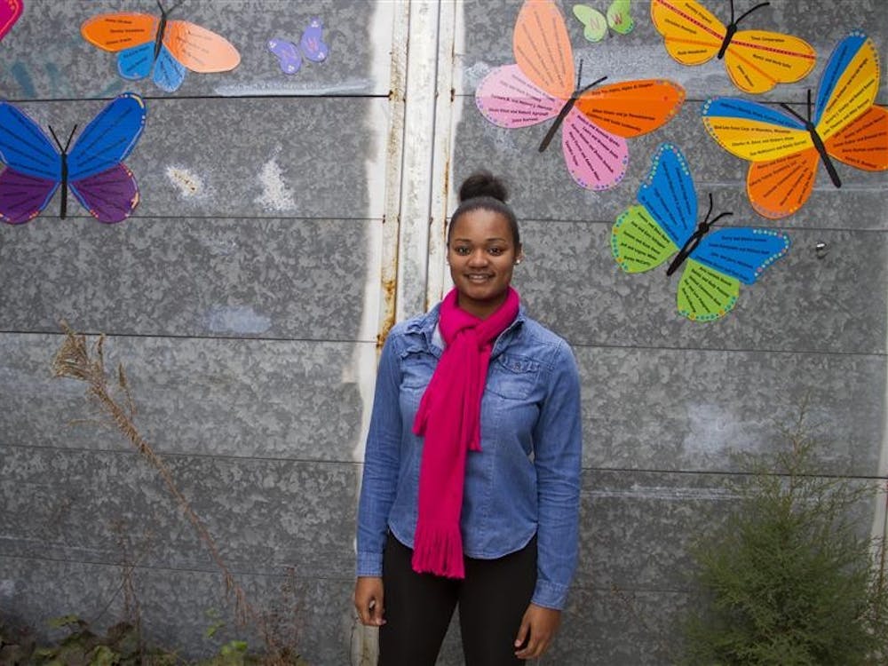 Senior Tempestt Walker stands at the entrance of the Middle Way House, where she has been volunteering since February.