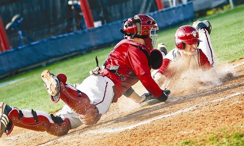 Sophomore catcher Wes Wilson makes an unsuccessful attempt at tagging freshman infielder Brian Ritz during game one of the Cream & Crimson World Series on Wednesday afternoon at Sembower Field. The Cream squad beat Crimson 6-2.