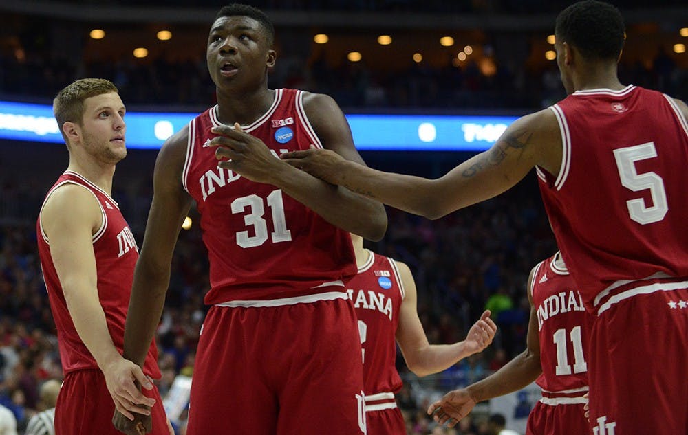 Redshirt senior forward Max Bielfeldt and junior forward Troy Williams embrace freshman center Thomas Bryant during the NCAA second round game against Kentucky on Saturday at the Wells Fargo Arena in Des Moines, Iowa. The Hoosiers won 73-67.