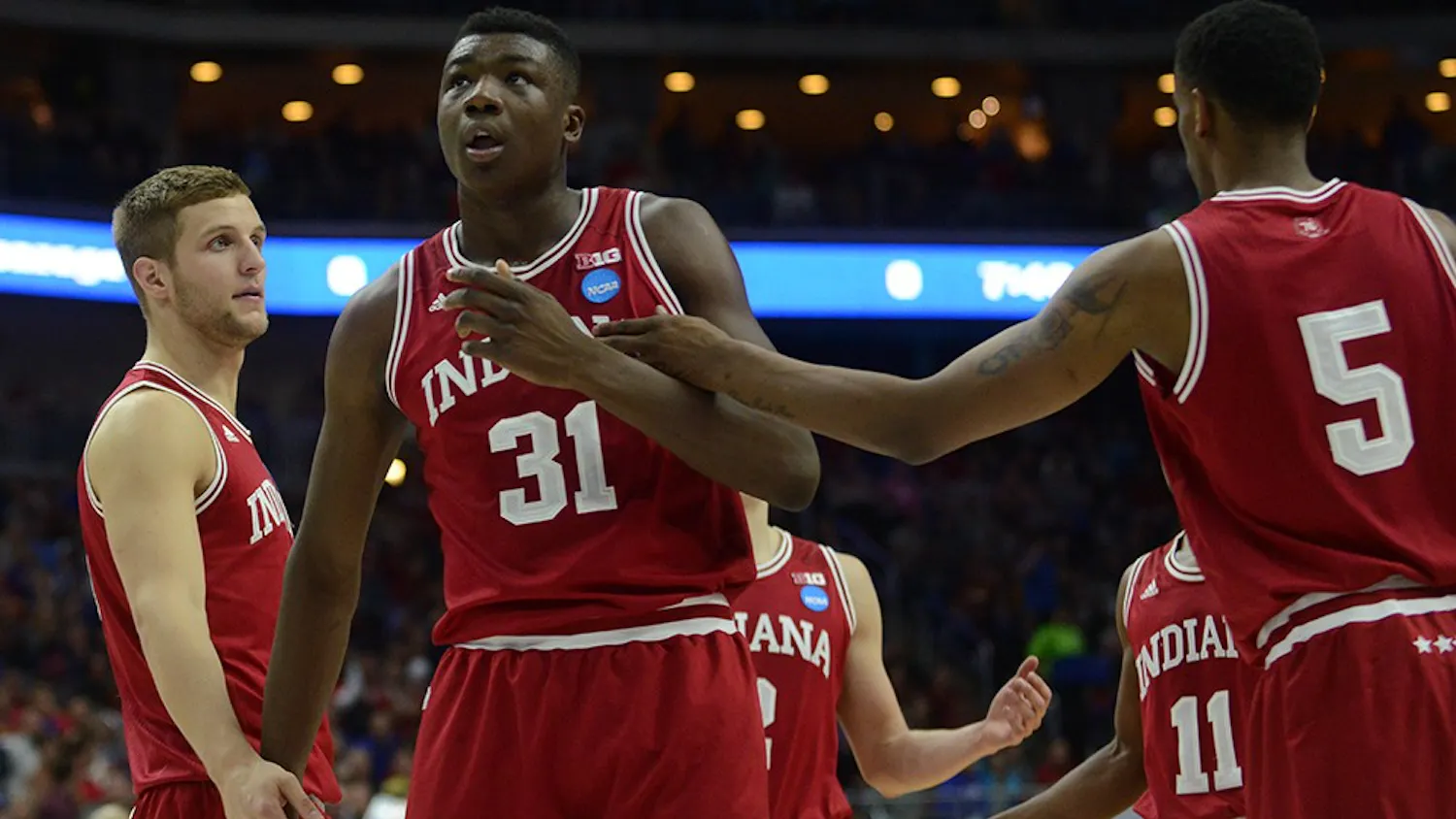 Redshirt senior forward Max Bielfeldt and junior forward Troy Williams embrace freshman center Thomas Bryant during the NCAA second round game against Kentucky on Saturday at the Wells Fargo Arena in Des Moines, Iowa. The Hoosiers won 73-67.