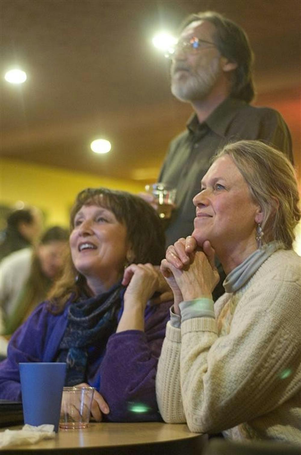 Irene Joslin, Perry Oles and Cheri Glaser watch on as clips of President Barack Obama's Inuaguration play Tuesday evening at Rachel's Cafe.
