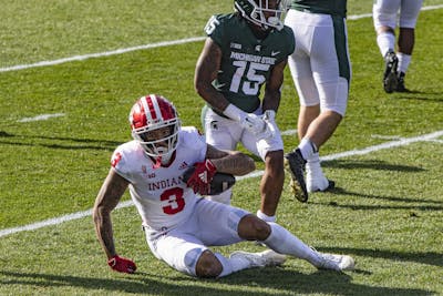 Senior wide receiver Ty Fryfogle holds the ball Nov. 14 in Spartan Stadium in East Lansing, Michigan. Fryfogle scored two touchdowns for No. 10 IU against Michigan State.